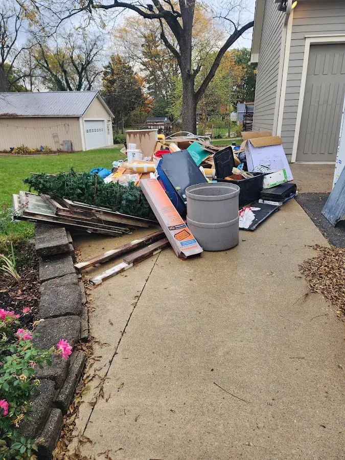 Dumpster being loaded with debris for Estate Cleanout Dumpster Rental in Fort Valley